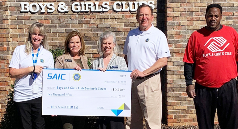 SAIC employees and officials present a check to Boys & Girls Clubs of North Alabama