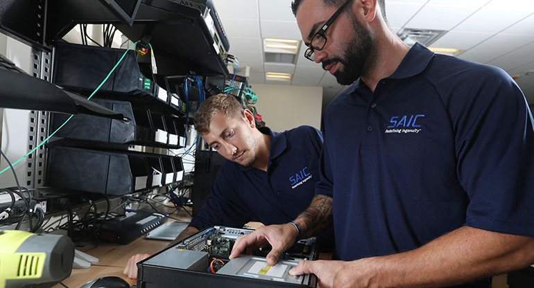 Two SAIC engineers are assembling the computer