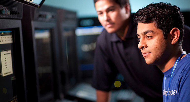 Two SAIC engineers working on the NASA EAST contract at their computers. 